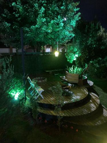a garden at night with a bench and trees at Suítes no Chalé - Cabanas in Campos do Jordão