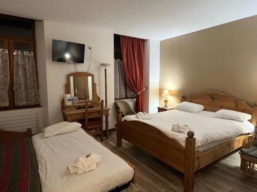 a hotel room with two beds and a mirror at Albert 1er in Albertville