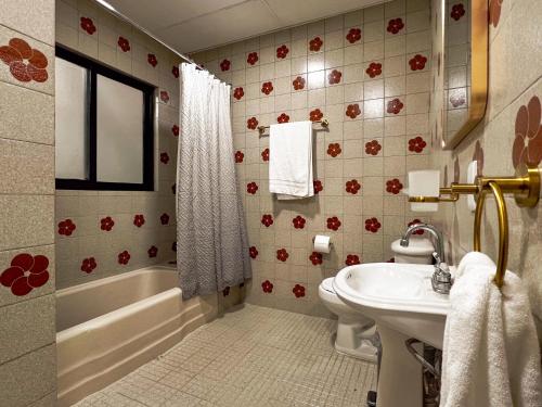 a bathroom with a sink and a toilet and a tub at Discover Condesa Ideal Location in Mexico City