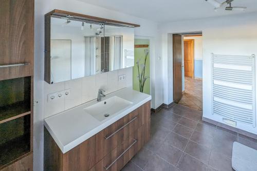 a bathroom with a sink and a mirror at Private Farmhouse Escape - Ideal for up to 8 Guests in Seeham