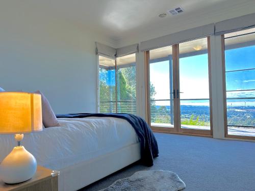 奧林達的住宿－Olinda Cascade Waterfall Mountain View Retreat，一间卧室设有一张床和大窗户