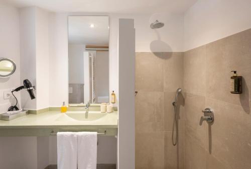 a bathroom with a sink and a shower at Palau Sa Font in Palma de Mallorca