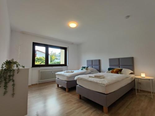 a room with two beds and a couch at 81qm, 3 bedroom, King-Bed, parking, fast Wifi, Netflix in Waiblingen
