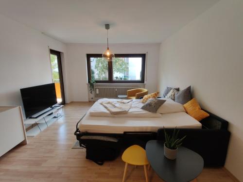 a bedroom with a large bed and a flat screen tv at 81qm, 3 bedroom, King-Bed, parking, fast Wifi, Netflix in Waiblingen