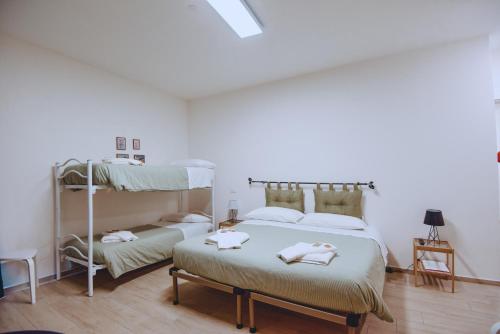 a bedroom with two beds and a bunk bed at Dimora Pardo in Larino
