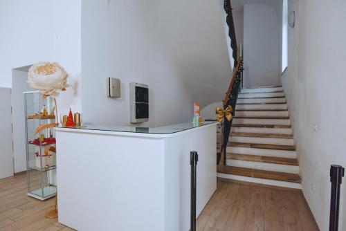 a room with a staircase and a white wall at Dimora Pardo in Larino