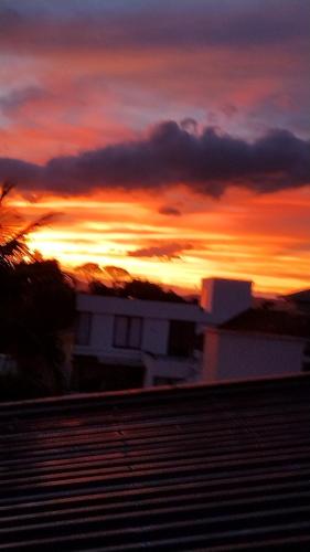 a sunset with the sun setting in the background at Recanto da Sol in Florianópolis