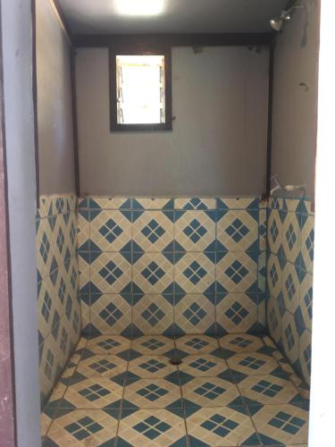 a room with a tiled floor and a window at Yawekata Eco Still Bluewater Lodge in Naviti Island