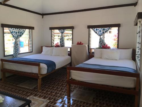 A bed or beds in a room at Yawekata Eco Still Bluewater Resort