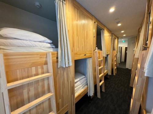 a row of bunk beds in a room at HOTEL PRELE ホテル プレール in Tokyo