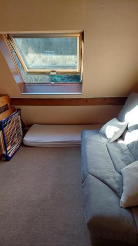 a room with a window and a couch and a window seat at Appartement au pied de la Crémaillère Express in Luchon
