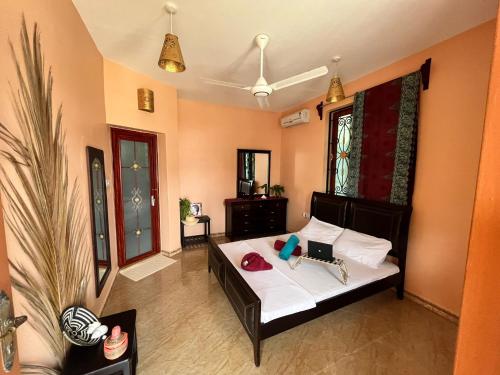 a bedroom with a bed with white sheets at Stardust Villa - ** Hotel in Paje
