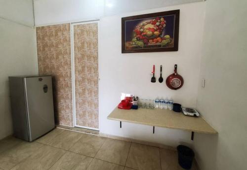 a kitchen with a counter and a refrigerator in a room at Departamento Bahia in Mazatlán