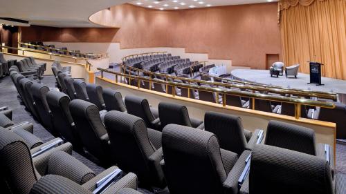 an auditorium with rows of chairs in front of a stage at InterContinental Abu Dhabi by IHG in Abu Dhabi