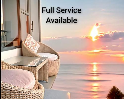 a balcony with a view of the ocean and a sunset at Manila BayView Rental- Luxury 1,2,3,4 BR Condos with BALCONY POOL BAYVIEW - FULL SERVICE INCLUDED IN MAY in Manila