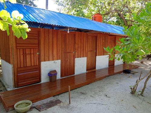 a wooden building with a bench in front of it at Happy Homestay Arborek in Besir