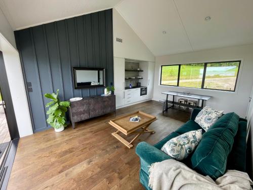 a living room with a couch and a table at Guesthouse @ Te Puna in Tauranga