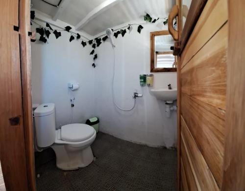 a bathroom with a toilet and a sink at Tour komodo in Labuan Bajo