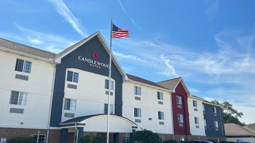 a building with an american flag on top of it at Candlewood Suites South Bend Airport by IHG in South Bend