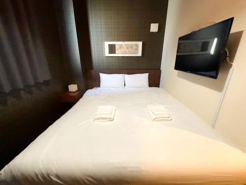 Ein Bett oder Betten in einem Zimmer der Unterkunft Ostay Kyoto west hotel APT