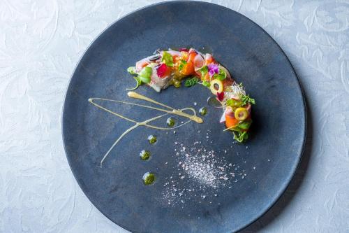 a blue plate with a piece of food on it at glampark ACONCAGUA RESORTS in Minami Aso