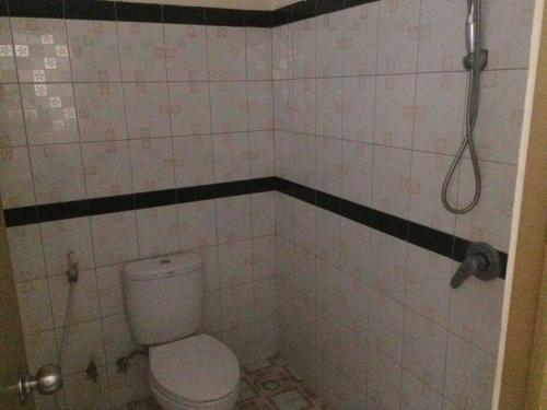 a bathroom with a toilet and a shower at simple apartment 2 in Seminyak