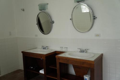 a bathroom with two sinks and a mirror at Bravo Beach Hotel in Vieques