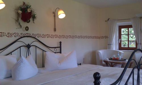 a bedroom with a bed with white pillows and a window at Romantik Hotel Zum Lindengarten in Kurort Jonsdorf