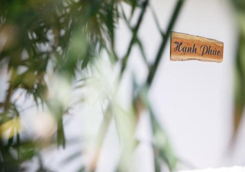 a sign that says roman police hanging on a tree at LUA Farmstay in Ba Ria