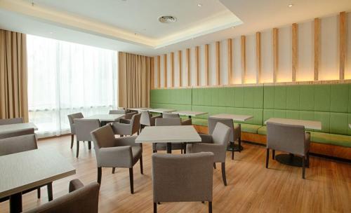 a restaurant with tables and chairs in a room at WP Hotel in Kuala Lumpur