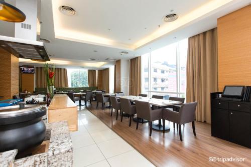 a dining room with tables and chairs in a restaurant at WP Hotel in Kuala Lumpur