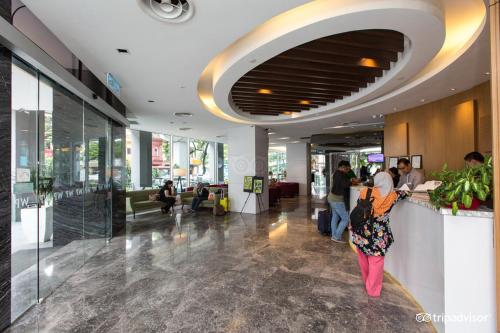 a group of people standing in a lobby at WP Hotel in Kuala Lumpur