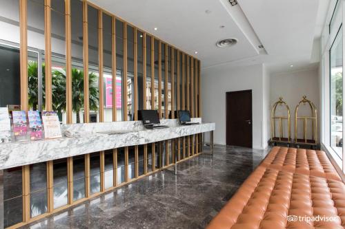 a lobby with a counter with two computers on it at WP Hotel in Kuala Lumpur