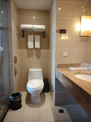 a bathroom with a toilet and a sink at Vienna International Hotel - Shanghai World Expo Garden in Shanghai