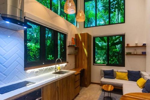 a kitchen with a sink and some windows at Condo VNV walking distance to the beach in Nosara