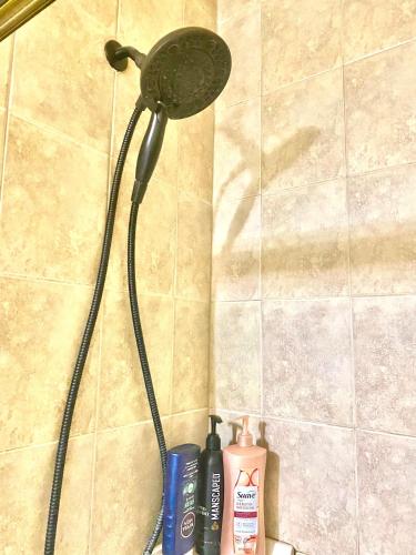 a shower with a shower head in a bathroom at B2 A private room in Naperville downtown with desk and Wi-Fi near everything in Naperville