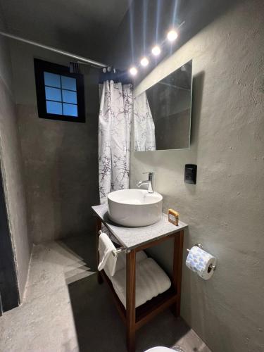 a bathroom with a white sink and a window at Lofts Marques Oaxaca in Oaxaca City