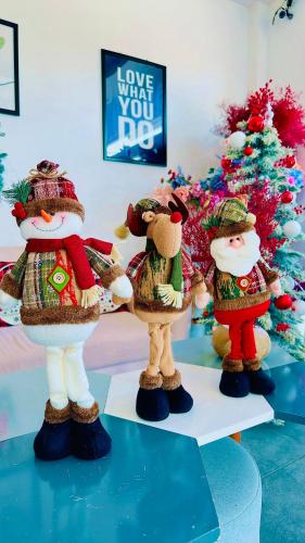 a group of three figurines in front of a christmas tree at Sele House in Ha Tien