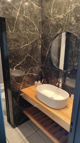 a bathroom with a sink and a mirror at Casa Manantial MAR AZUL in Mar Azul