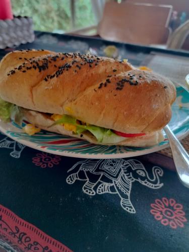 a sandwich on a plate on a table at Tulip Resort Pai in Pai