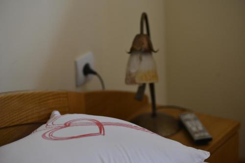 a bedroom with a bed and a lamp on a table at Motel Kneginja in Čačak