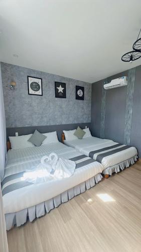 a room with three beds in a room at Sele House in Ha Tien