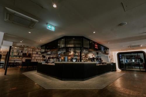 a bar in a room with a lot of alcohol at Sydney Junction Hotel in Hamilton