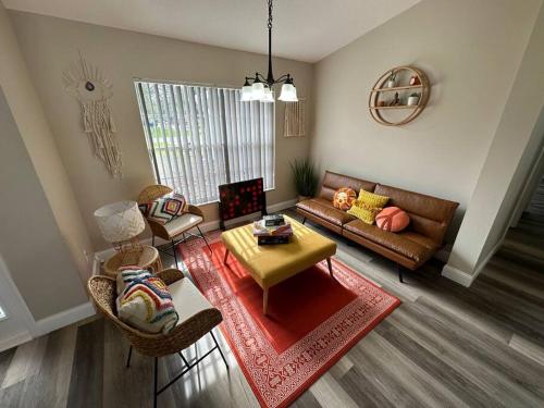 a living room with a couch and a table at Manatee Oasis Weeki Wachee Family Fun Pool Home in Spring Hill
