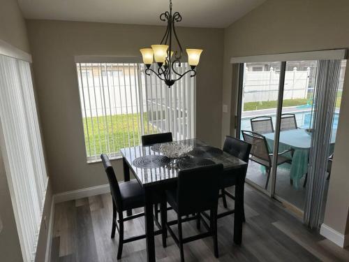 a dining room with a table and chairs and a dining roomiasm at Manatee Oasis Weeki Wachee Family Fun Pool Home in Spring Hill