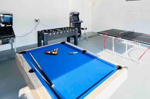 a pool table in a room with a table at Manatee Oasis Weeki Wachee Family Fun Pool Home in Spring Hill