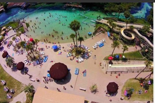 an overhead view of a beach with people in the water at Manatee Oasis Weeki Wachee Family Fun Pool Home in Spring Hill