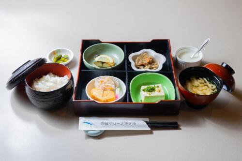 a tray of food with rice and bowls of food at Iki Marina Hotel in Iki