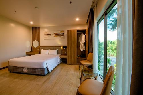 a hotel room with a bed and a balcony at ZEN RIVERSIDE HOTEL & RESIDENCES in Hai Phong
