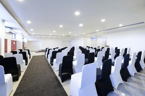 a conference room with white and black chairs at Clover - A Rivido Hotel Jigani in Bengaluru